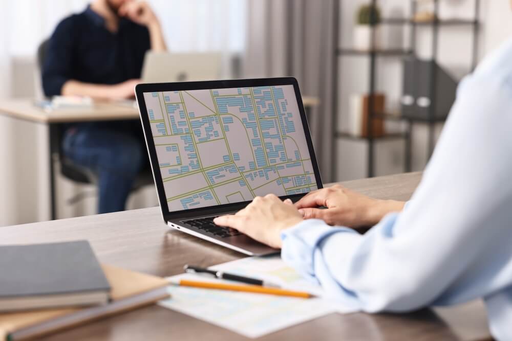 Person using digital map for route planning on laptop